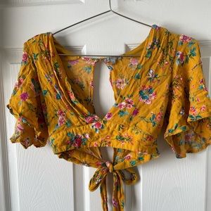 This a Charlotte Russe floral crop tie back shirt. Size XS